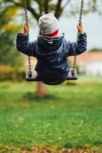 boy swinging up on swing