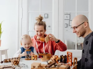 Parents spending time with their child at home, supported by professional childcare in London