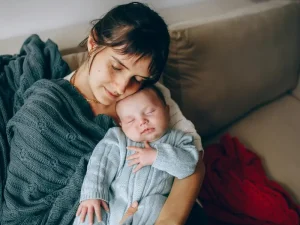New mother at home in London recovering after birth with professional childcare and maternity nurse support in place