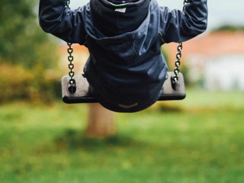 boy swinging up on swing